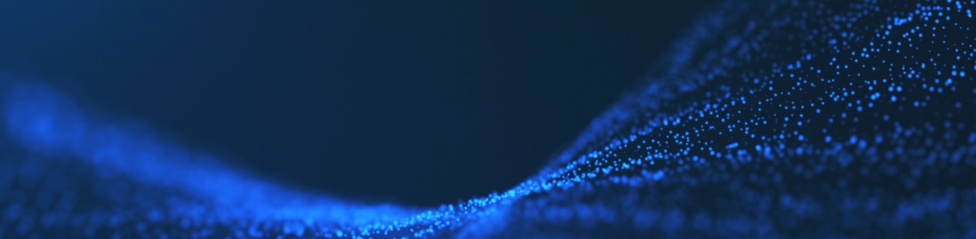 Blue particle wave flowing across the screen, depicting a dynamic, glowing curve of blue light composed of small, bright dots on a dark background.