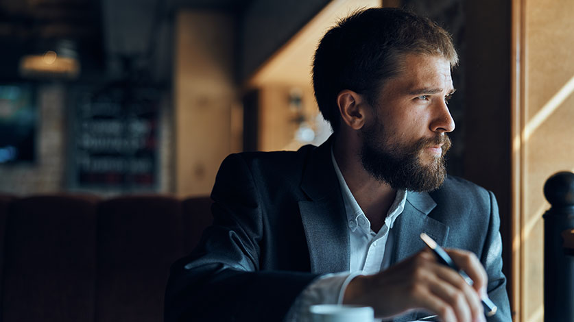 confident man looking out of window