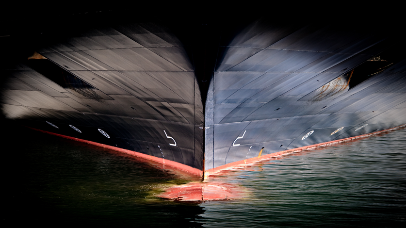 A close-up of a ship sailing gracefully on the water, showcasing its intricate details and the vastness of the surrounding sea.