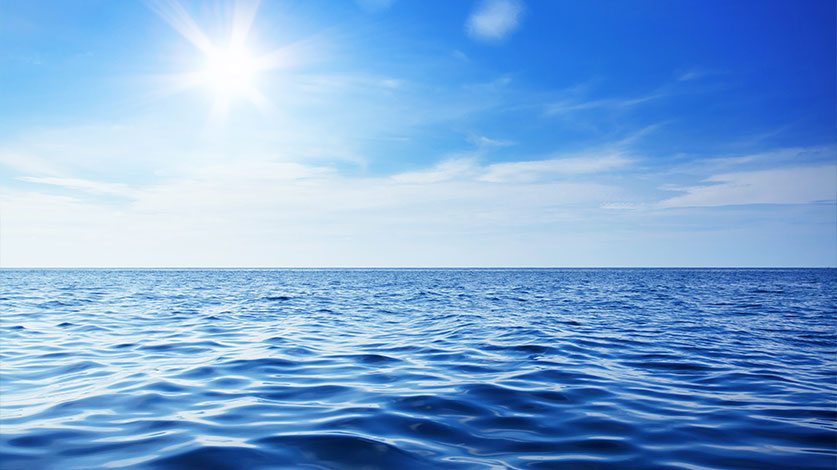 sun over a blue sea