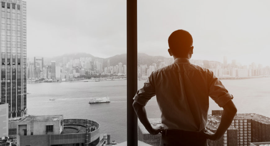 man at window of building