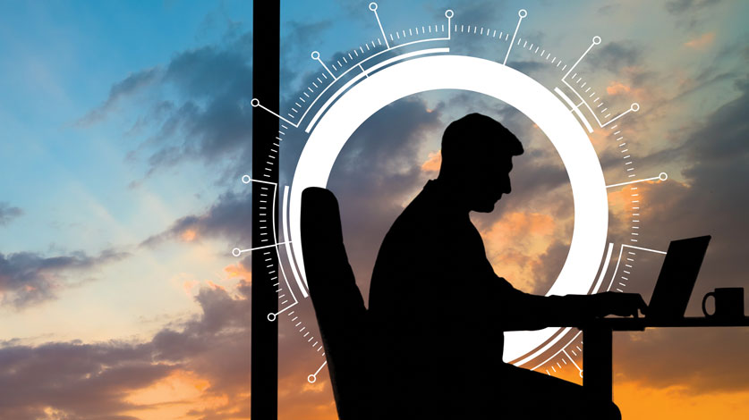 man in office at sunset